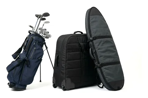 Golf bag with clubs, a black travel case and a long padded bag